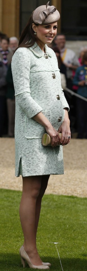 Britain's Catherine, Duchess of Cambridge, showing visible signs of pregnancy, meets scouts at Windsor Castle in Berkshire wearing Mulberry
