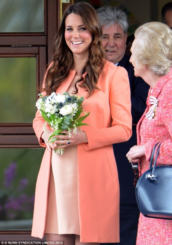 Radiant- The Duchess of Cambridge was wearing a peach £375 Tara Jarmon coat yesterday